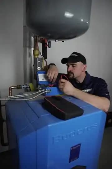 A Prospector technician installing a water heater