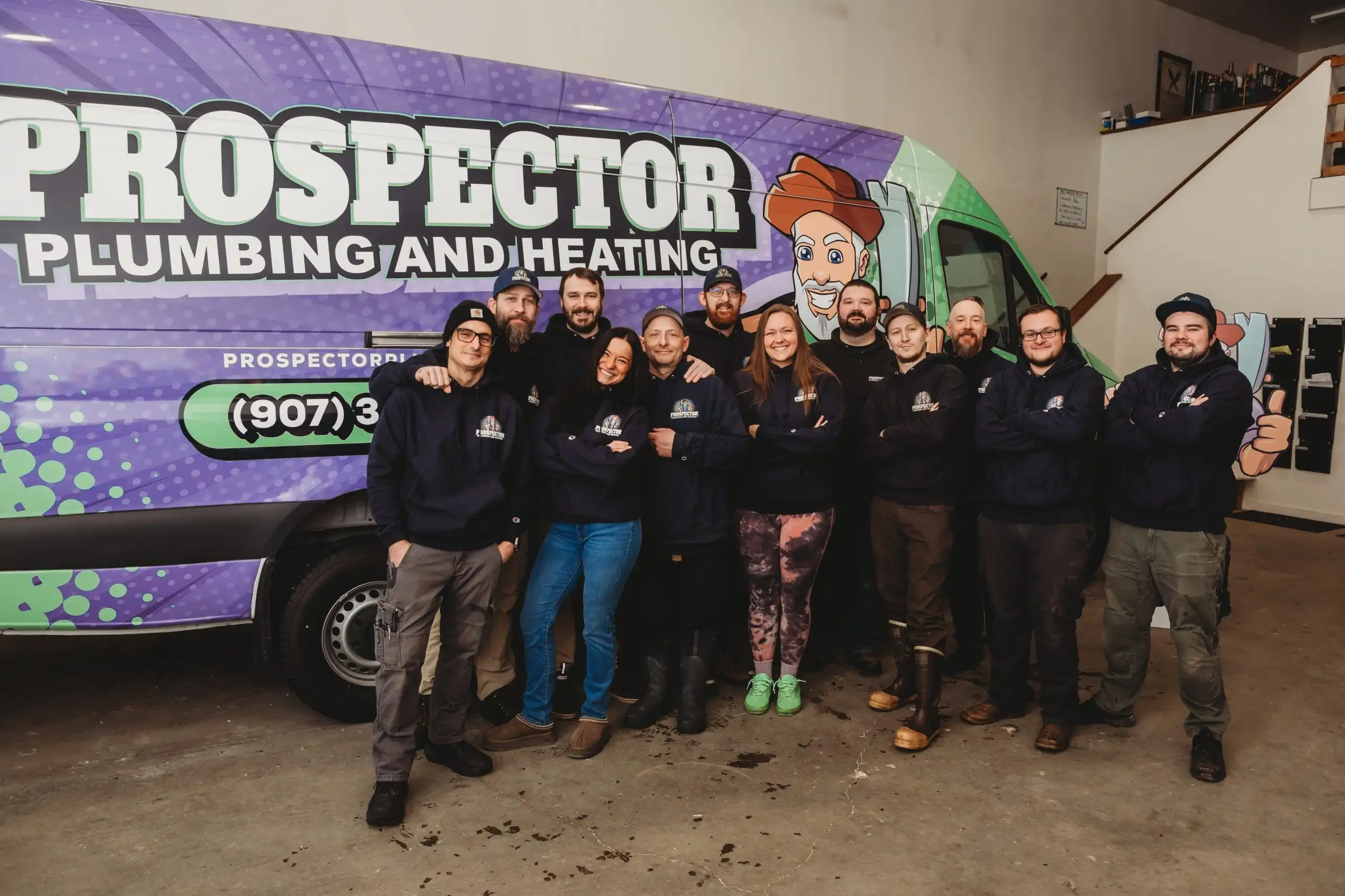The Prospector Plumbing and Heating team in front of a branded truck